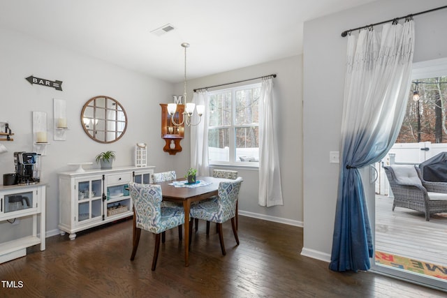 dining room with a chandelier and dark wood-type flooring