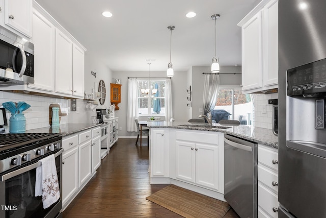 kitchen featuring light stone countertops, white cabinetry, and stainless steel appliances