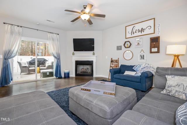 living room featuring dark hardwood / wood-style floors and ceiling fan