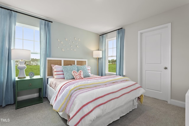 carpeted bedroom featuring multiple windows