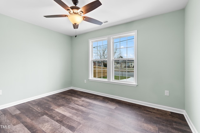 unfurnished room with ceiling fan and dark hardwood / wood-style floors