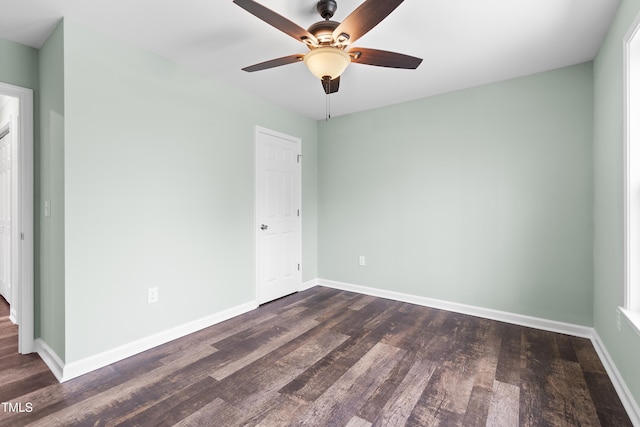 spare room with ceiling fan and dark hardwood / wood-style floors