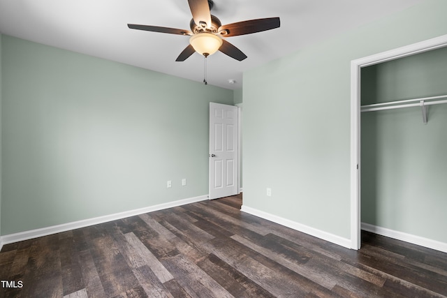 unfurnished bedroom featuring ceiling fan, dark hardwood / wood-style flooring, and a closet