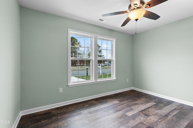 unfurnished room with ceiling fan and dark hardwood / wood-style flooring