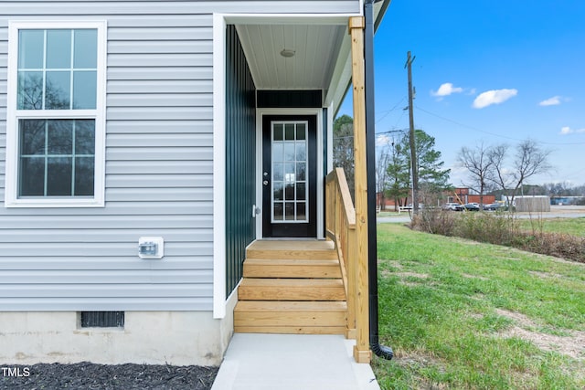 doorway to property featuring a yard