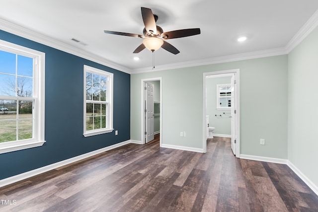 unfurnished bedroom with dark hardwood / wood-style flooring, ceiling fan, a spacious closet, connected bathroom, and a closet