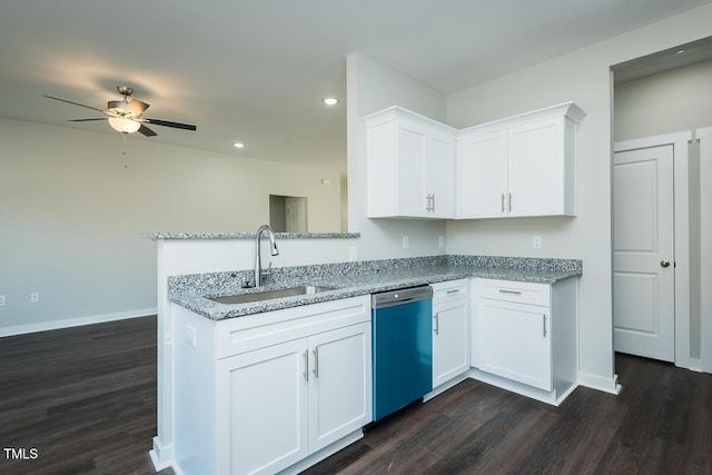 kitchen with dishwashing machine, light stone counters, dark wood-type flooring, a sink, and white cabinetry