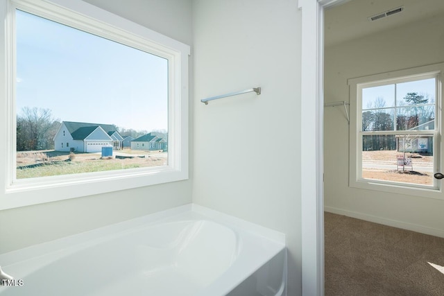 bathroom featuring visible vents and a bath