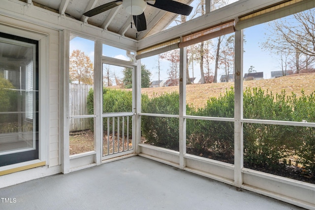 unfurnished sunroom featuring plenty of natural light, lofted ceiling, and ceiling fan