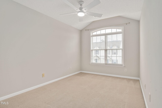 unfurnished room featuring light carpet, a textured ceiling, vaulted ceiling, and ceiling fan