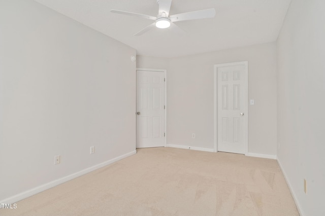 carpeted spare room with ceiling fan