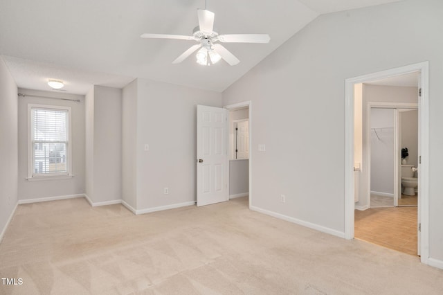 unfurnished bedroom featuring ceiling fan, light colored carpet, and a spacious closet