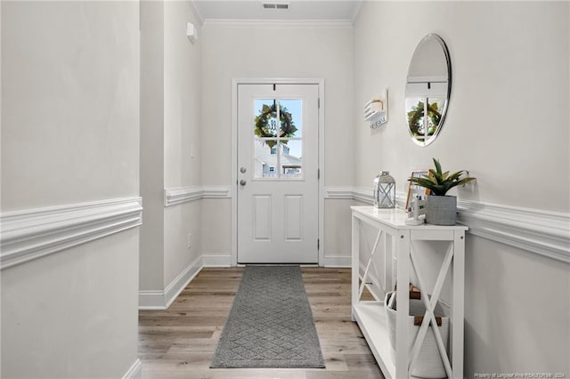 entrance foyer with crown molding and light wood-type flooring