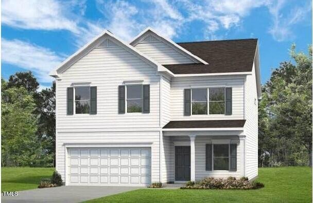 view of front of house featuring a garage and a front yard