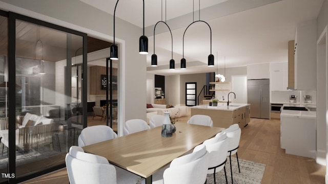 dining room with light hardwood / wood-style floors and sink