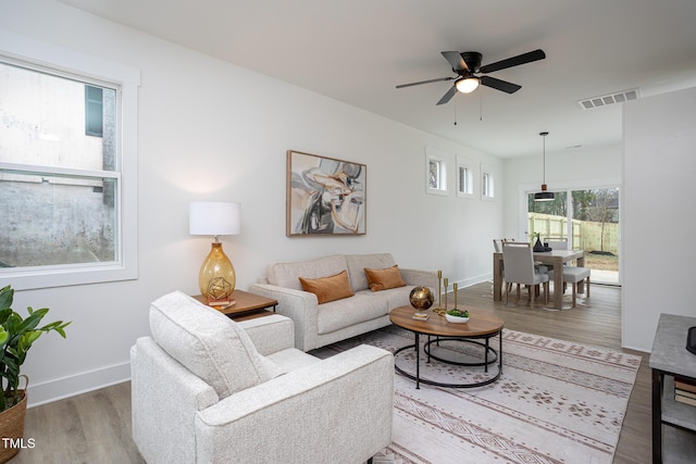 living room featuring ceiling fan and hardwood / wood-style floors