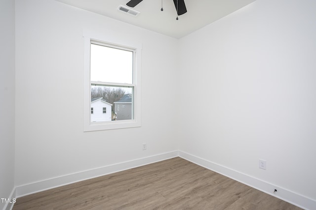 spare room with hardwood / wood-style floors and ceiling fan