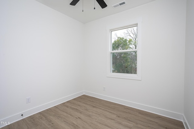 unfurnished room with hardwood / wood-style floors and ceiling fan