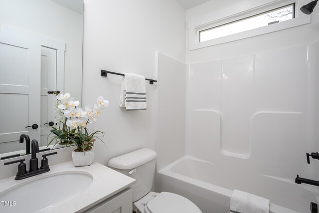 full bathroom with shower / tub combination, vanity, and toilet