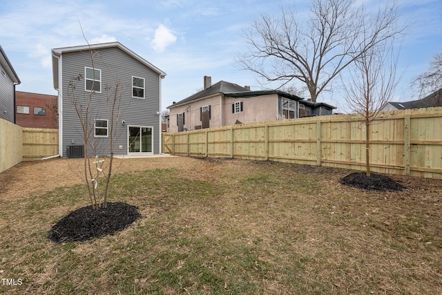 rear view of property featuring cooling unit and a yard