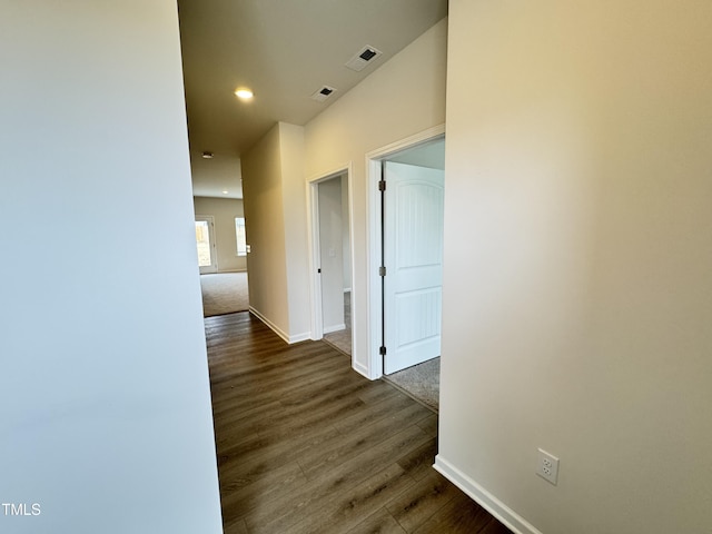 corridor with dark hardwood / wood-style flooring