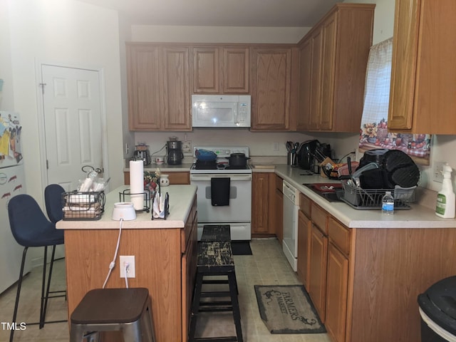 kitchen featuring a breakfast bar and white appliances