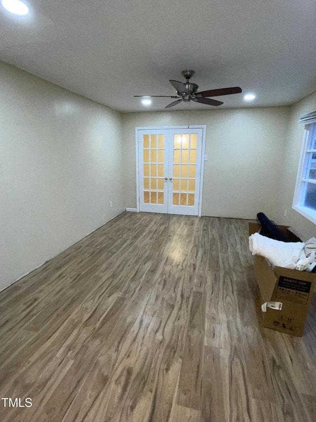 unfurnished living room featuring wood-type flooring and french doors