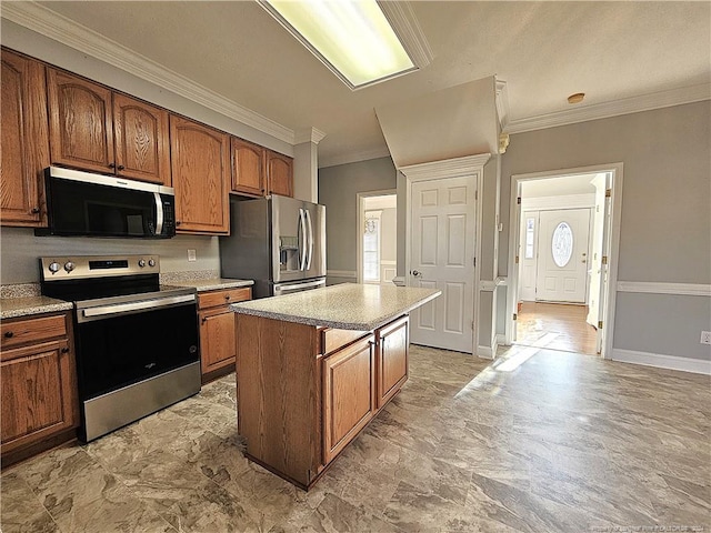 kitchen featuring a center island, stainless steel appliances, and crown molding