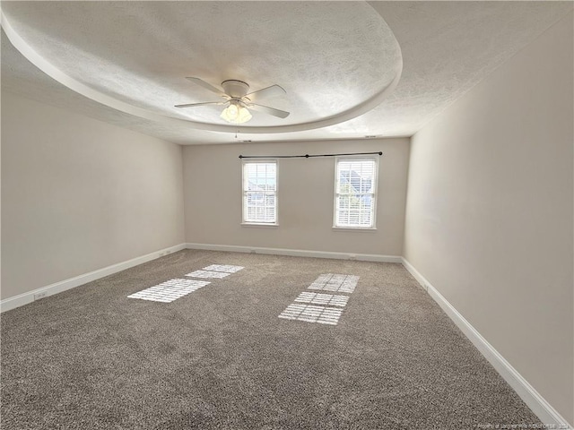 carpeted spare room featuring ceiling fan and a textured ceiling