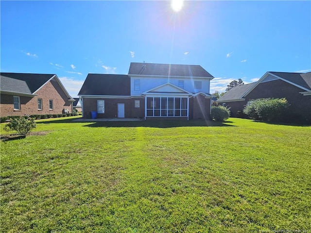 rear view of house featuring a yard