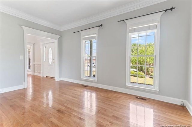 unfurnished room featuring light hardwood / wood-style flooring and ornamental molding