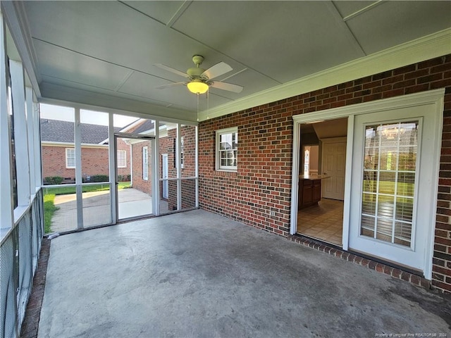 unfurnished sunroom with ceiling fan