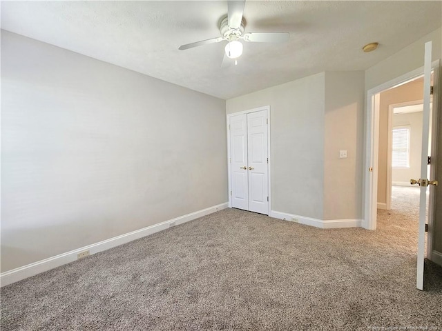 spare room featuring carpet and ceiling fan