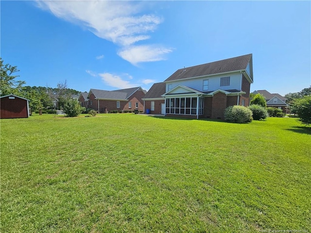 back of house featuring a sunroom and a yard