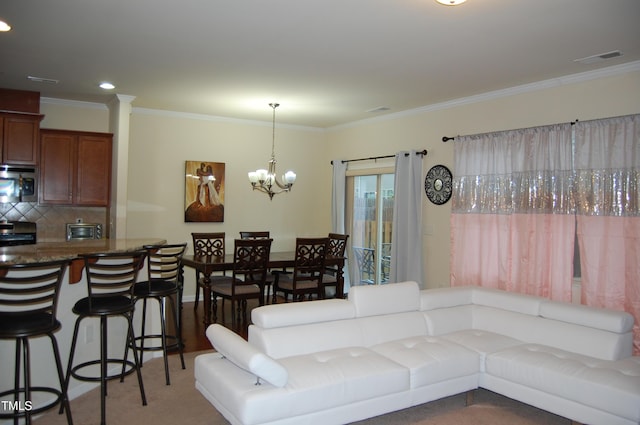 living room featuring carpet, a notable chandelier, and crown molding