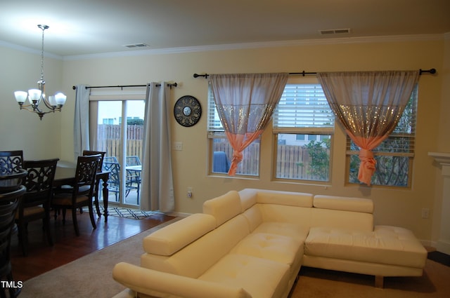 living room with a chandelier, dark hardwood / wood-style flooring, and ornamental molding