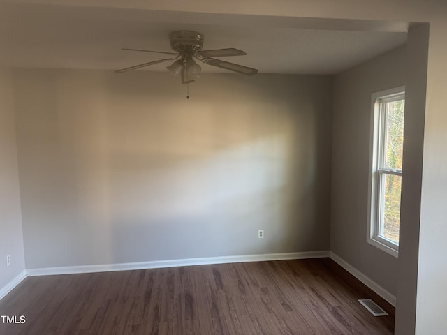 spare room with dark hardwood / wood-style floors and ceiling fan