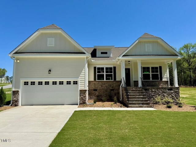 19 Covey Rise Way, Lillington, NC 27546 - craftsman-style home with stone siding, a front yard, driveway, and covered porch