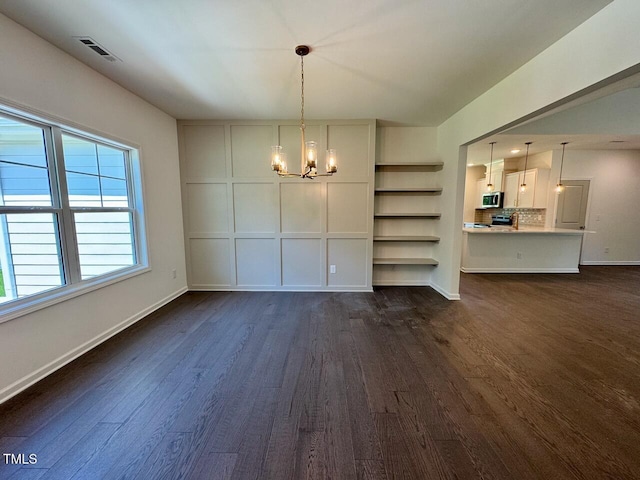 19 Covey Rise Way, Lillington, NC 27546 - unfurnished dining area with dark wood finished floors and a chandelier