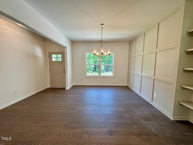 19 Covey Rise Way, Lillington, NC 27546 - unfurnished dining area featuring a chandelier, dark wood-style flooring, and built in features