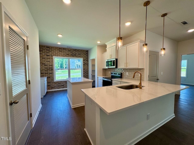 19 Covey Rise Way, Lillington, NC 27546 - kitchen with stainless steel microwave, range with electric cooktop, a kitchen island, plenty of natural light, and brick wall