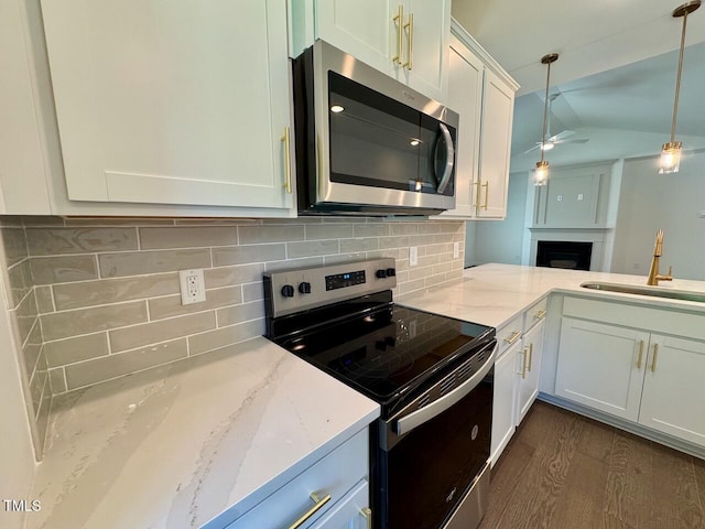 19 Covey Rise Way, Lillington, NC 27546 - kitchen featuring stainless steel microwave, range with electric cooktop, a ceiling fan, tasteful backsplash, and lofted ceiling