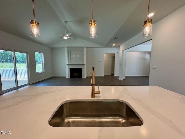 19 Covey Rise Way, Lillington, NC 27546 - kitchen with open floor plan, light stone countertops, a ceiling fan, a fireplace, and lofted ceiling