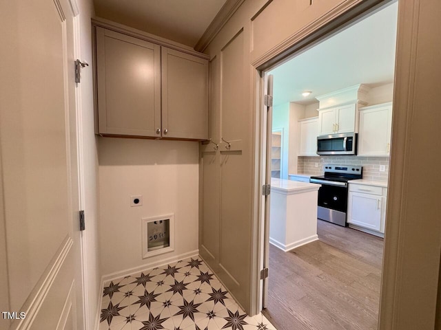 19 Covey Rise Way, Lillington, NC 27546 - laundry room with electric dryer hookup, cabinet space, and light wood finished floors