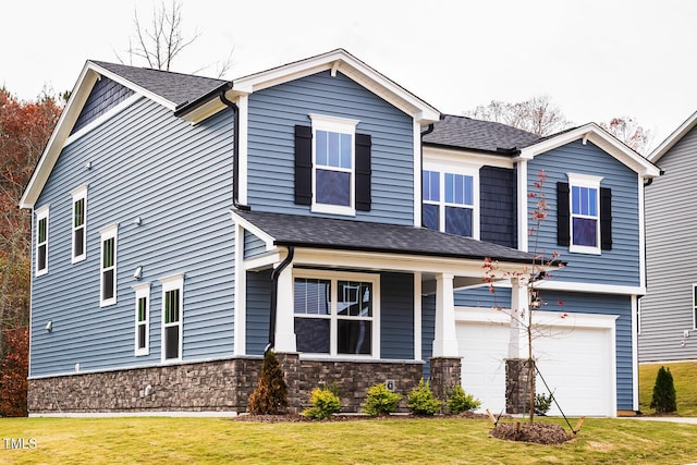 craftsman inspired home with a garage and a front yard