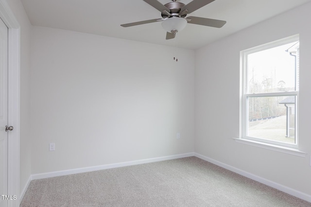 carpeted empty room featuring ceiling fan