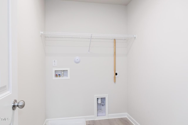 laundry area featuring hookup for an electric dryer, hookup for a washing machine, hookup for a gas dryer, and light hardwood / wood-style flooring