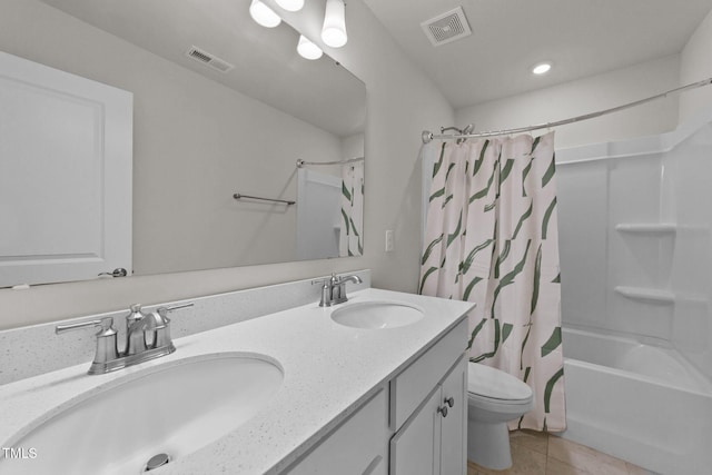 full bathroom with shower / bath combo with shower curtain, tile patterned floors, vanity, and toilet