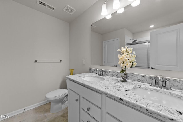 bathroom with toilet, tile patterned flooring, a shower with shower door, and vanity