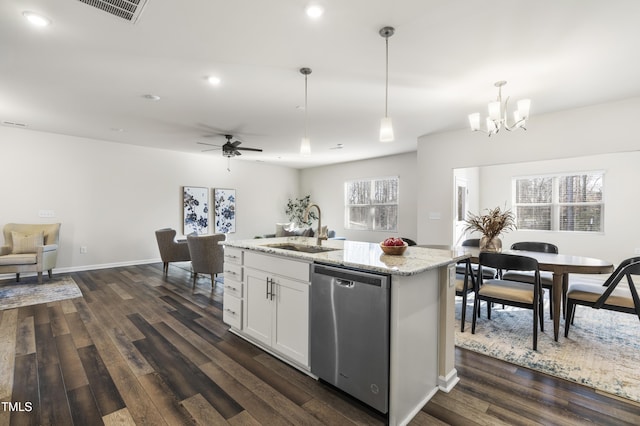 kitchen with an island with sink, pendant lighting, stainless steel dishwasher, white cabinets, and sink